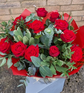 Dozen red roses in a vase